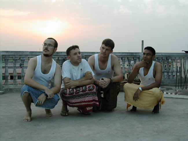 Men in lungis contemplating