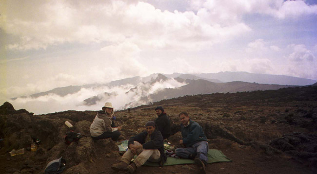 Laura, Moazam, Wassiem, and Anjun having a snack of popcorn, peanuts, and tea