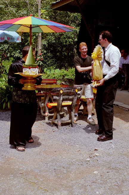 Colin, Aarron, and Orion waiting for the elephants and distributing gifts to carry