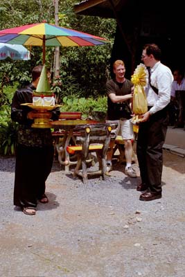 Colin, Aarron, and Orion waiting for the elephants and distributing gifts to carry