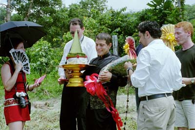 Colin approaches the wood gate, where red envelopes containing money will be presented to Melissa and Evan, the gate keepers. 