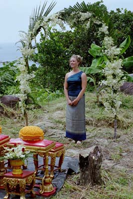 Laura awaiting Colin's arrival under the flower arch